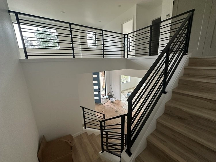 Stylish interior featuring black railings on a staircase, highlighting the modern design.