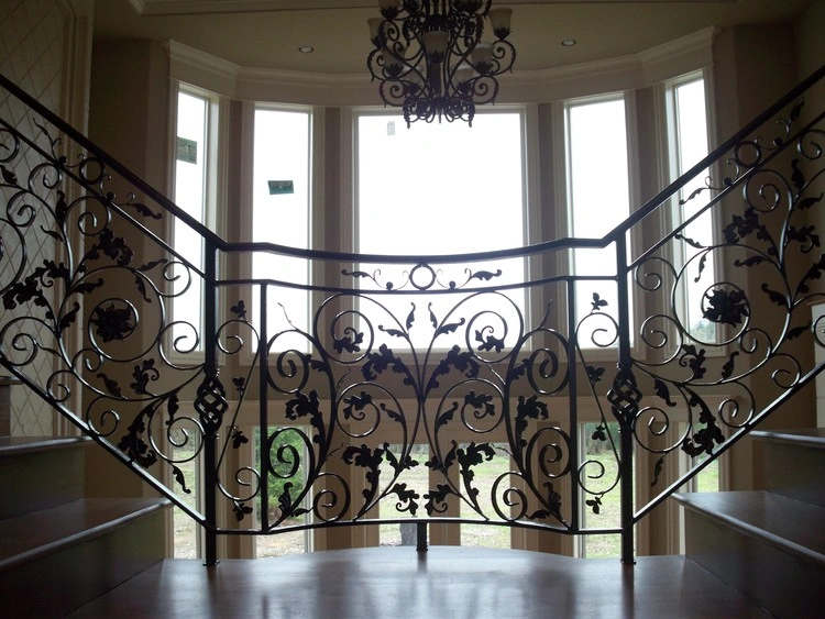 A detailed CNC and structural railing with intricate floral patterns, complementing the elegant staircase.